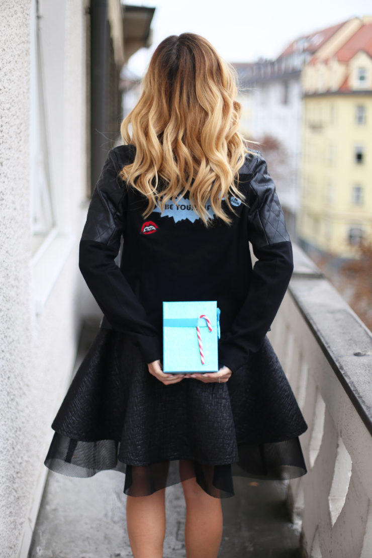 blue present, black leatherjacket, dress